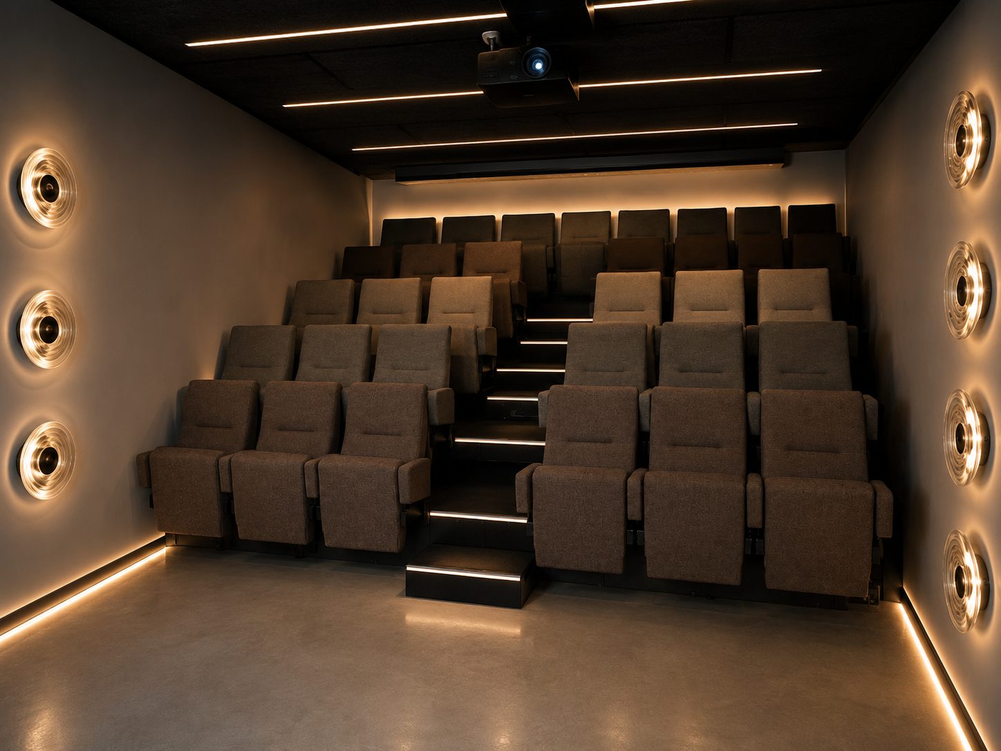The screening room seats viewed from the front, lit by warm wall lights and low level strip lighting